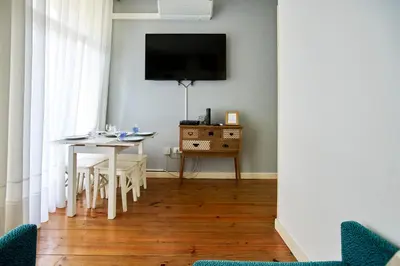 a bedroom with a large bed with white sheets at Market Place (with 2 Bedrooms) by JC in Porto