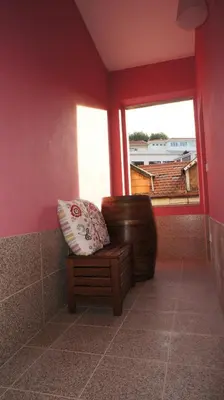 a chair sitting in a room with a window at Hostel Gaia Porto in Vila Nova de Gaia