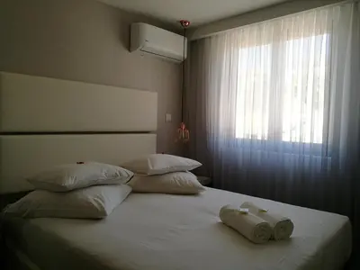a bed with two towels on it with a window at Hostel Gaia Porto in Vila Nova de Gaia