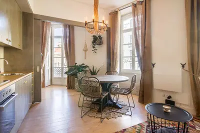 a kitchen with a table and chairs in a room at Little Capeli in Porto