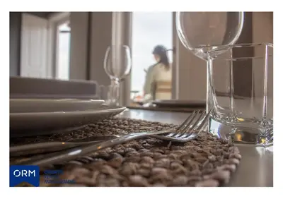 a table with a fork and plates and a glass at ORM Praça Apartment in Porto