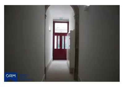 a hallway with a red door in a building at ORM Praça Apartment in Porto