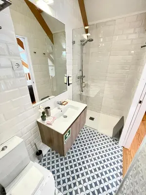 a bathroom with a sink and a shower and a toilet at 1118 Lofts in Porto