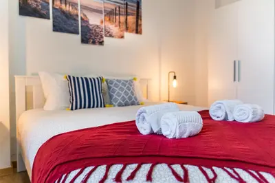 a bedroom with a bed with towels on it at Porto Belo Bolhao Apartments - Free Parking in Porto