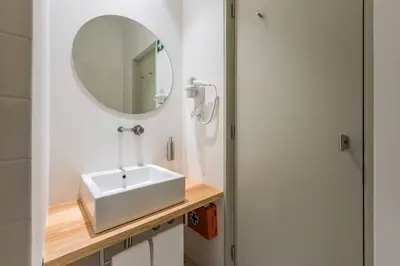 a bathroom with a sink and a mirror at Casas das Caldeiras in Porto