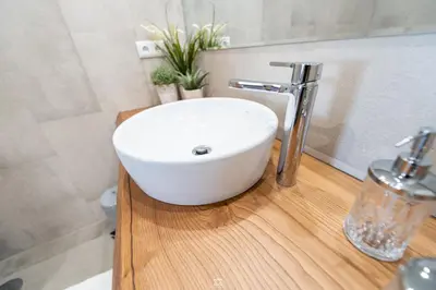 a white sink on a wooden counter in a bathroom at Porto Cathedral in Porto