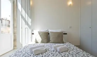 a bed with two pillows on it in a bedroom at A da Maria Ildefonso in Porto