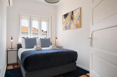 a bedroom with a bed and a window at Poveiros Terrace - 3BR Downtown apartment with AC in Porto