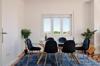 a dining room with a table and chairs at Poveiros Terrace - 3BR Downtown apartment with AC in Porto