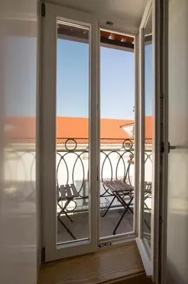 a sliding glass door with a view of a balcony at Porto and Clérigos Views by Porto City Hosts in Porto