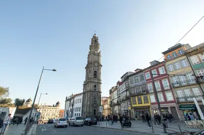 a tall clock tower in a city with buildings at Porto and Clérigos Views by Porto City Hosts in Porto