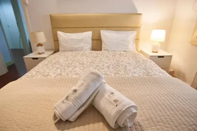 a bedroom with a bed with two towels on it at Riverside (with 3 Bedrooms) by JC in Porto
