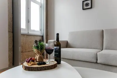 a bottle of wine and a glass on a table at Santa Catarina Downtown II in Porto