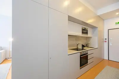 a kitchen with white cabinets and a sink at Santa Catarina Downtown II in Porto
