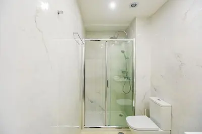 a bathroom with a shower and a toilet at Santa Catarina Downtown II in Porto