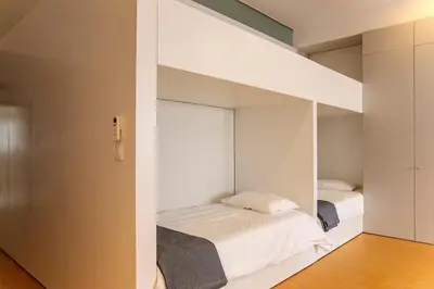 a bedroom with two beds and a large mirror at Santa Catarina Downtown III in Porto