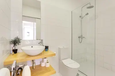 a bathroom with a sink and a toilet and a shower at January's 31 Studio by DA'HOME in Porto