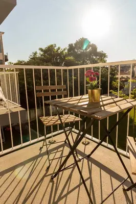 a balcony with a table with a vase of flowers on it at Guest H4U - Bonjardim Pop Art City Center in Porto