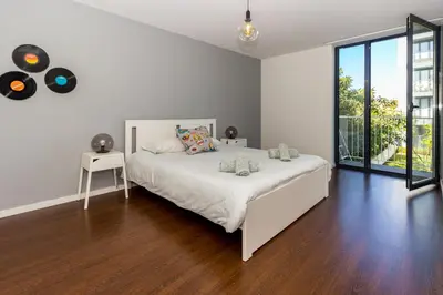 a living room with a couch and a tv at Guest H4U - Bonjardim Pop Art City Center in Porto