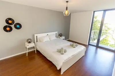 a white bedroom with a large bed and a window at Guest H4U - Bonjardim Pop Art City Center in Porto