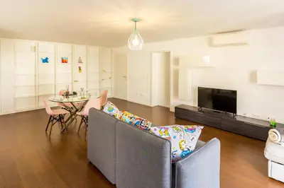 a living room with a couch and a table and a tv at Guest H4U - Bonjardim Pop Art City Center in Porto