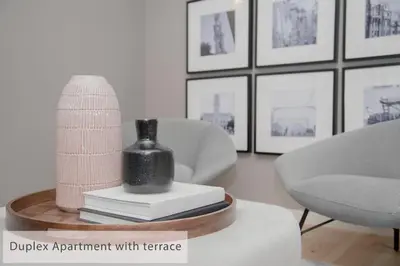a living room with a vase sitting on top of a table at Alegria Residence in Porto