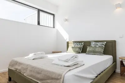 a bedroom with a bed with towels on it at VIVA In the MOOD in Porto