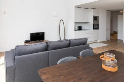 a living room with a gray couch and a wooden table at VIVA In the MOOD in Porto