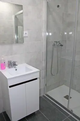 a bathroom with a sink and a shower at Guest House Henrique VIII in Porto
