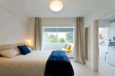 a bedroom with a large bed and a window at L&M Apartment in Porto