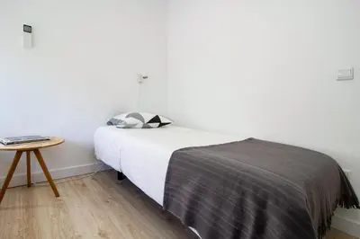 a bedroom with a bed and a small table at Casa de Gaia in Vila Nova de Gaia
