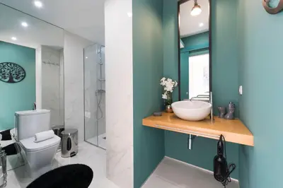 a bathroom with a sink and a toilet and a mirror at LovelyStay - Wohaza Apartment with free private parking in Porto