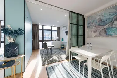 a living room with a white table and chairs at LovelyStay - Wohaza Apartment with free private parking in Porto
