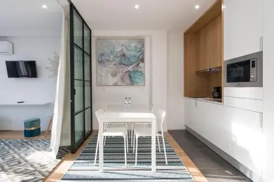 a kitchen with a white table and two chairs at LovelyStay - Wohaza Apartment with free private parking in Porto