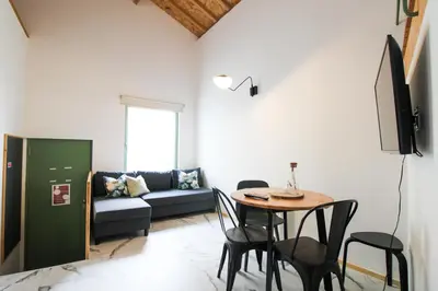 a living room with a table and a couch at Macário Cosy Loft in Porto