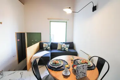 a living room with a table and a couch at Macário Cosy Loft in Porto