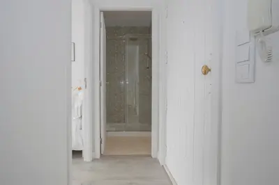 a white hallway with a shower in a bathroom at Liiiving in Porto | Center Spot Apartment in Porto