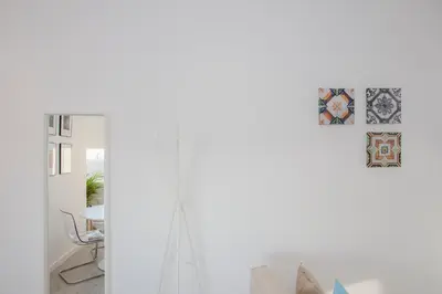 a room with a white wall with a cross on it at Liiiving in Porto | Center Spot Apartment in Porto