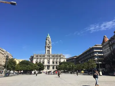a large building with a clock tower in a city at CASA JOY Boavista apartment in Porto