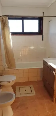 a bathroom with a toilet and a sink and a tub at City Heart Rooms in Porto