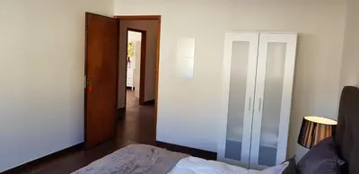 a bedroom with a bed and a closet and a hallway at City Heart Rooms in Porto