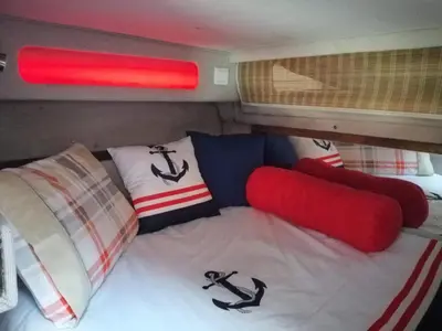 a bed in the back of a trailer with pillows at SLEEPBOAT Barco Hotel in Porto