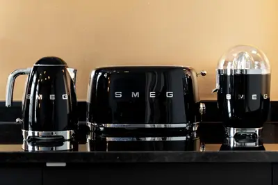 two black coffee cups sitting on a counter at The White Box Boutique House in Porto