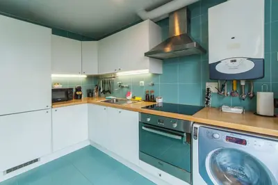 a kitchen with white cabinets and a dishwasher at NiP Apartment | Porto City Center Near All Sights in Porto