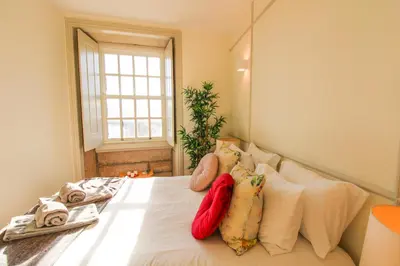 a bedroom with a bed with pillows and a window at Douro Divine in Porto