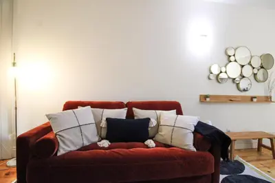 a red couch with pillows on it in a living room at Douro Divine in Porto