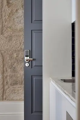 a blue door with a remote control on it at Mayor's Apartments in Porto