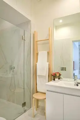 a white bathroom with a shower and a sink at Mayor's Apartments in Porto