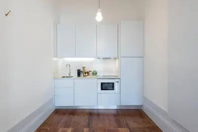 a kitchen and dining room with a table and chairs at Tripas-Coração, Sá da Bandeira in Porto