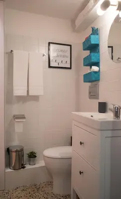 a white bathroom with a toilet and a sink at SP199 Flat in Porto